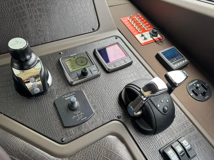 Miss Understood Yacht Photos Pics Control panel of a 2015 Azimut 64 yacht with navigation and throttle systems.