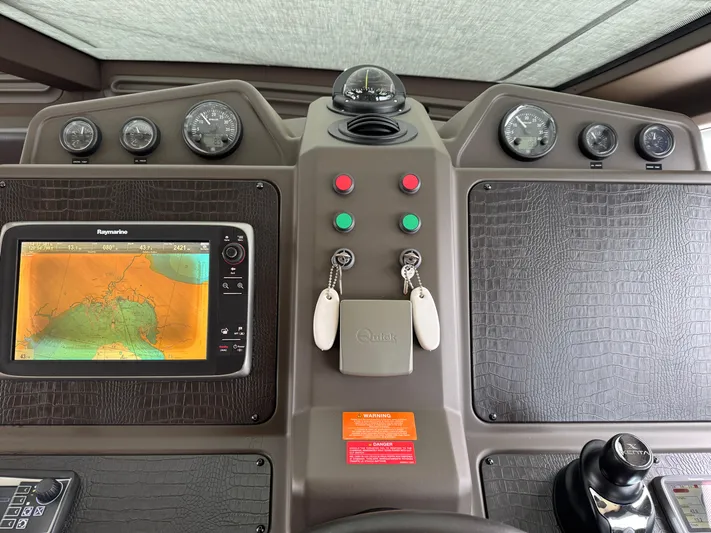 Miss Understood Yacht Photos Pics Control panel of a 2015 Azimut 64 yacht with navigation display and gauges.