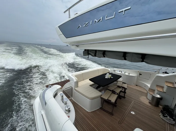 Miss Understood Yacht Photos Pics Luxury Azimut 64 yacht cruising, featuring elegant deck seating and ocean view.