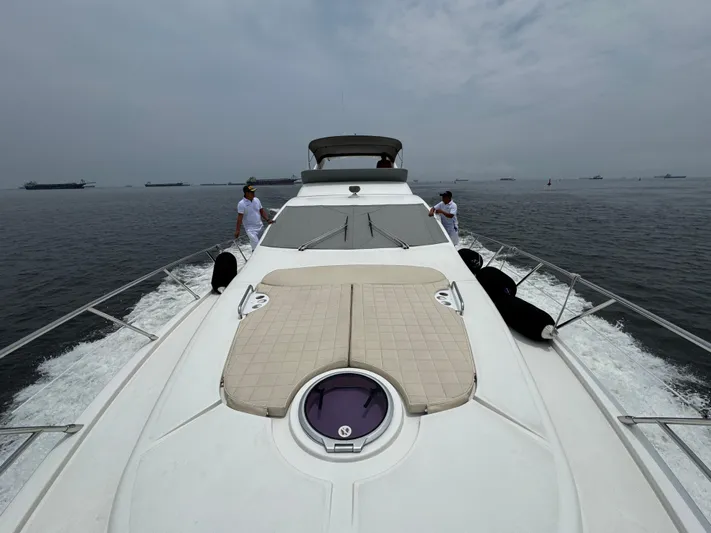 Miss Understood Yacht Photos Pics 2015 Azimut 64 yacht cruising on open water with crew on deck.
