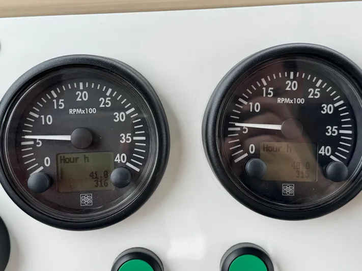 Miss Understood Yacht Photos Pics Close-up of Azimut 64 yacht's RPM gauges, displaying engine hours and RPM readings.