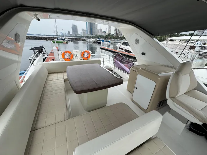 Miss Understood Yacht Photos Pics Luxurious 2015 Azimut 64 yacht interior with seating and table, docked at marina.
