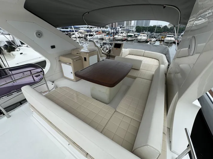 Miss Understood Yacht Photos Pics Luxurious 2015 Azimut 64 yacht interior with elegant seating and wooden table at marina.