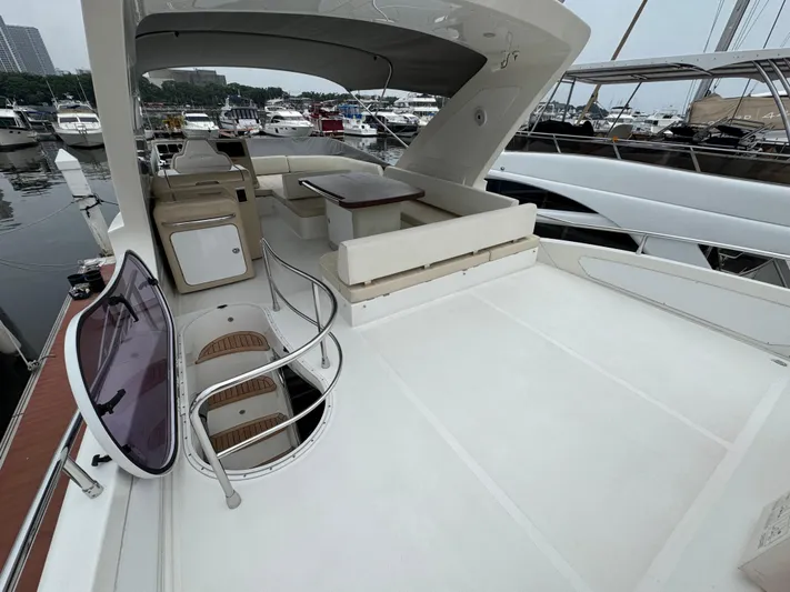 Miss Understood Yacht Photos Pics Azimut 64 yacht 2015 model, spacious deck with seating area, docked at marina.