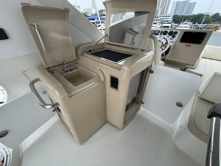 Miss Understood Yacht Photos Pics Luxury yacht Azimut 64 (2015) cockpit with sink, grill, and helm station.