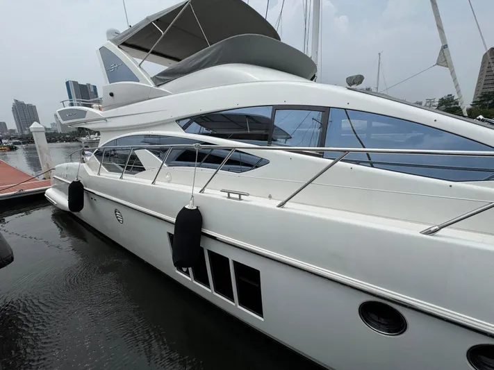 Miss Understood Yacht Photos Pics Luxury 2015 Azimut 64 yacht docked at marina, sleek design, modern architecture.