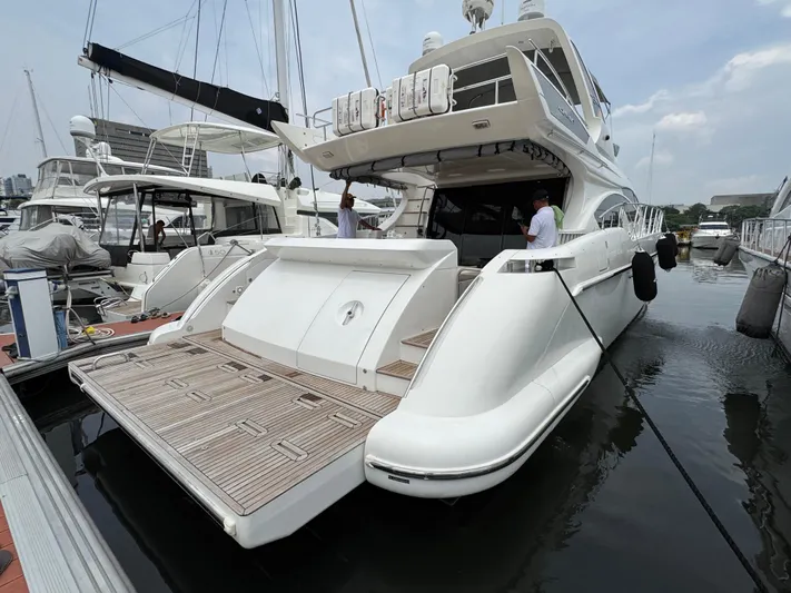 Miss Understood Yacht Photos Pics Luxury 2015 Azimut 64 yacht docked at marina, showcasing sleek design and spacious deck.