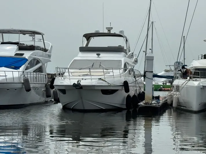Miss Understood Yacht Photos Pics Luxury 2015 Azimut 64 yacht docked at marina, surrounded by other boats.