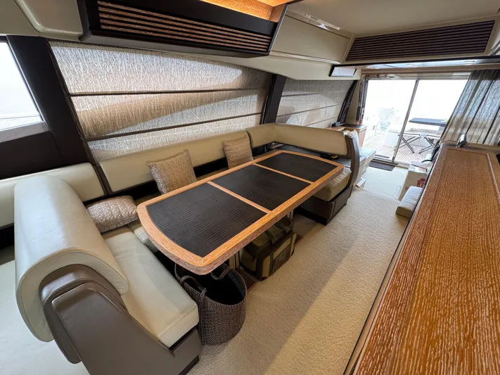 Miss Understood Yacht Photos Pics Luxurious interior of a 2015 Azimut 64 yacht with elegant seating and dining area.