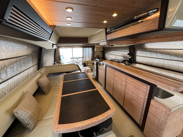 Miss Understood Yacht Photos Pics Luxurious interior of a 2015 Azimut 64 yacht with elegant wood finishes and modern design.