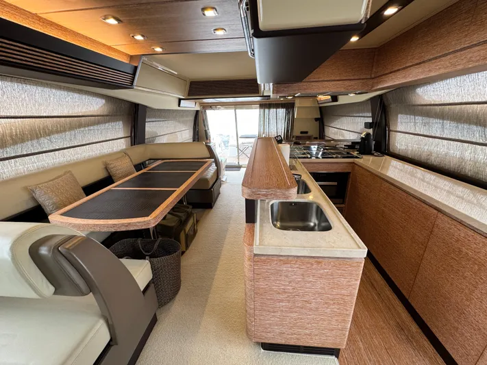 Miss Understood Yacht Photos Pics Luxurious interior of a 2015 Azimut 64 yacht with modern kitchen and dining area.