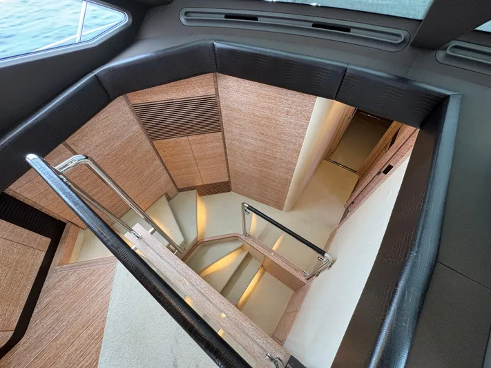 Miss Understood Yacht Photos Pics Staircase inside 2015 Azimut 64 yacht, featuring modern wood paneling and sleek design.