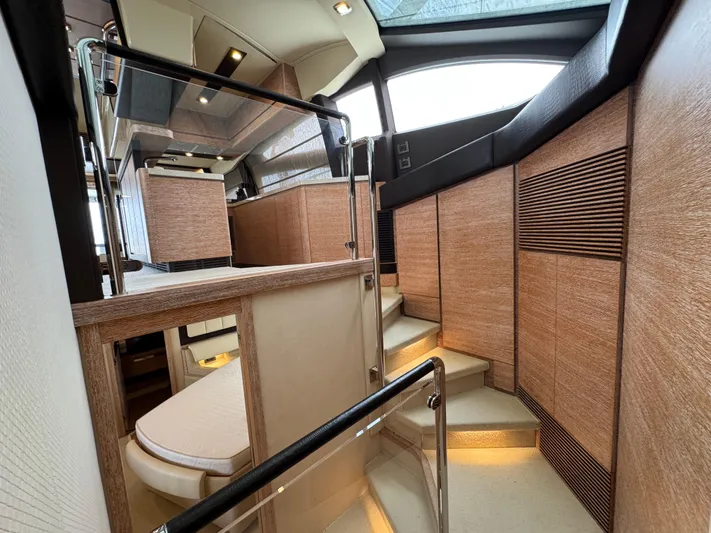 Miss Understood Yacht Photos Pics Luxurious interior of a 2015 Azimut 64 yacht with modern wood paneling and elegant design.