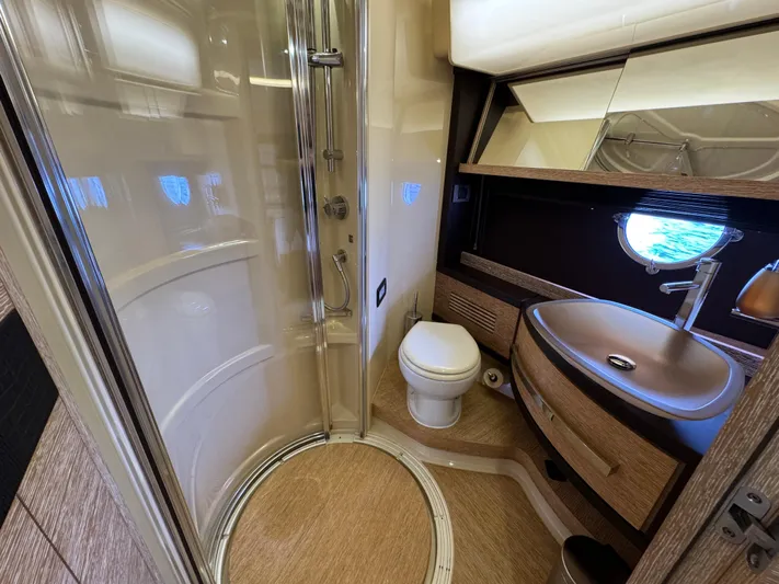 Miss Understood Yacht Photos Pics Luxurious bathroom in 2015 Azimut 64 yacht with shower, sink, and toilet.