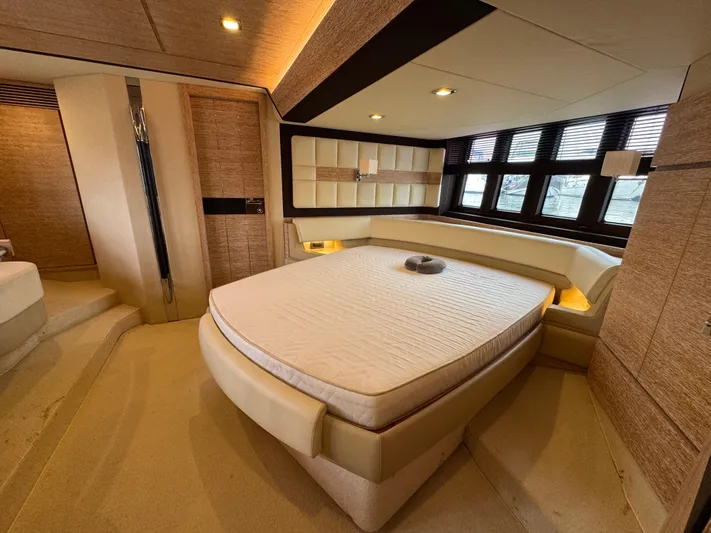 Miss Understood Yacht Photos Pics Luxurious bedroom interior of a 2015 Azimut 64 yacht with modern design and large windows.