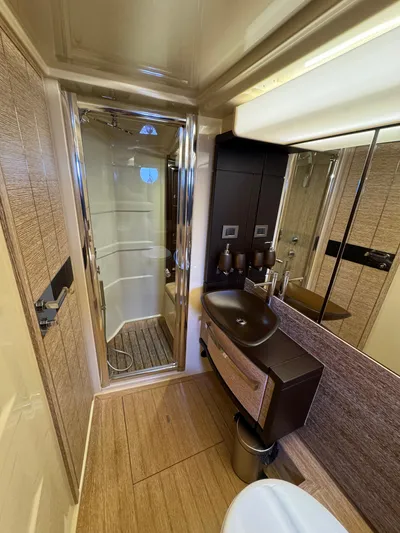 Miss Understood Yacht Photos Pics Luxurious bathroom in 2015 Azimut 64 yacht with modern fixtures and elegant design.