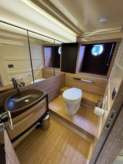 Miss Understood Yacht Photos Pics Luxurious bathroom interior of 2015 Azimut 64 yacht with modern fixtures and wood accents.