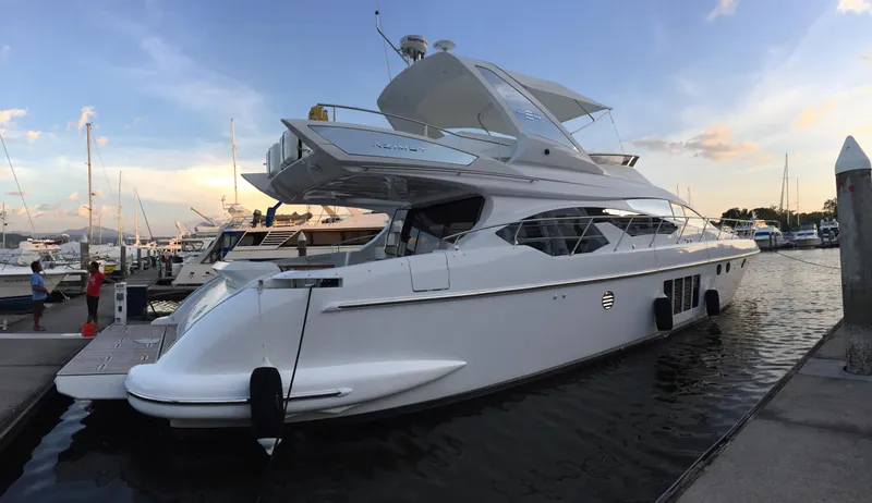 Miss Understood Yacht Photos Pics Luxury 2015 Azimut 64 yacht docked at marina during sunset.