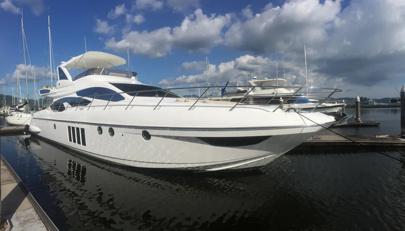 Miss Understood Yacht Photos Pics Luxurious 2015 Azimut 64 yacht docked at marina under blue sky.