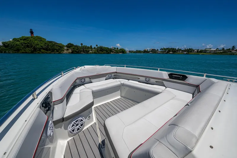  Yacht Photos Pics 2019 Formula 430 Super Sport Crossover boat interior on a sunny day, near lush shoreline.
