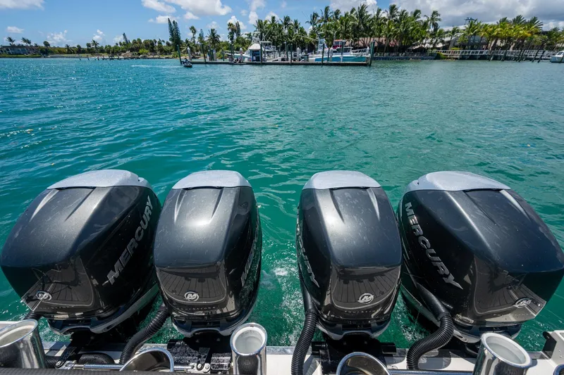  Yacht Photos Pics Four Mercury outboard engines on a 2019 Formula 430 Super Sport Crossover, docked by a tropical shoreline.