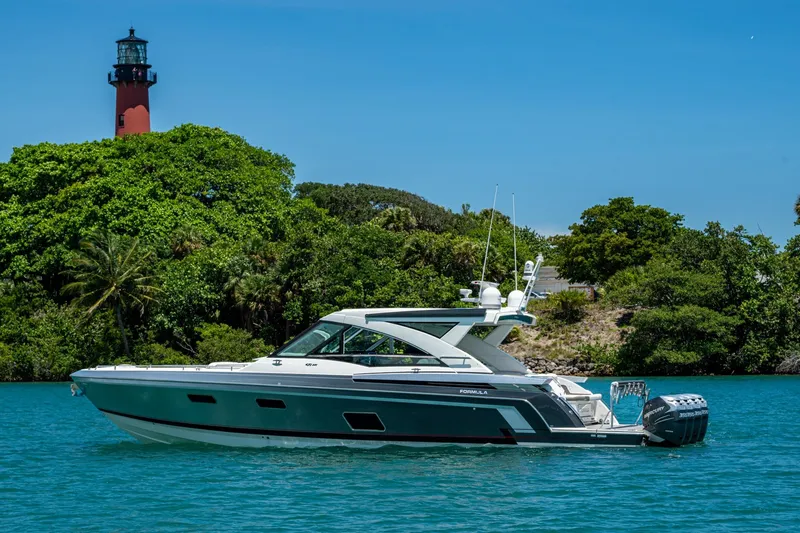  Yacht Photos Pics 2019 Formula 430 Super Sport Crossover yacht near lush island and lighthouse.