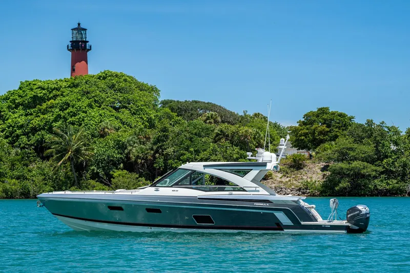  Yacht Photos Pics 2019 Formula 430 Super Sport Crossover yacht near lush island with lighthouse.