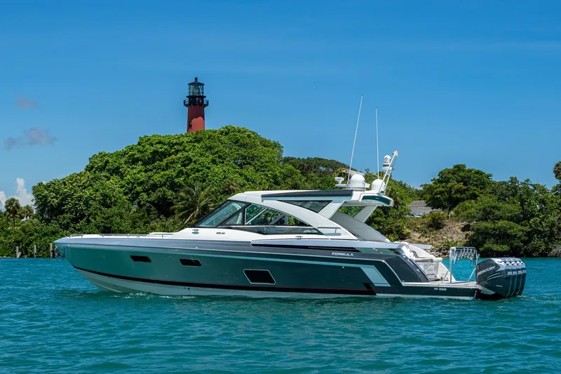  Yacht Photos Pics 2019 Formula 430 Super Sport Crossover yacht near lush island and lighthouse.