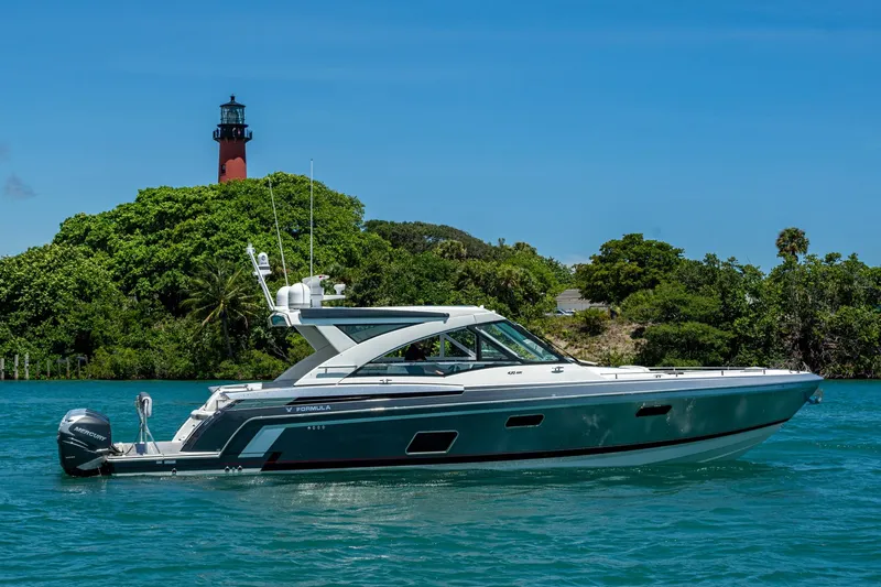  Yacht Photos Pics 2019 Formula 430 Super Sport Crossover yacht near lush island and lighthouse.