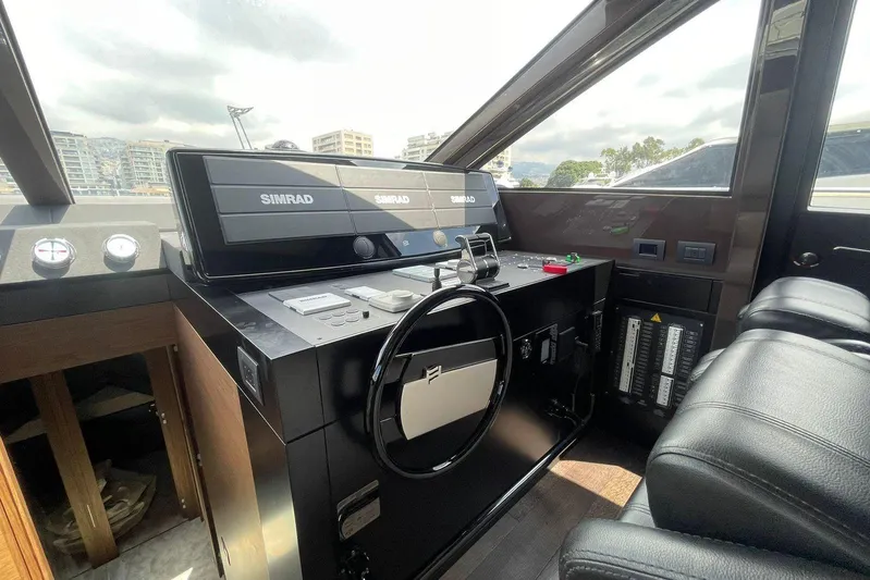  Yacht Photos Pics Cockpit of 2021 Ferretti Yachts 670 with Simrad navigation system and leather seating.