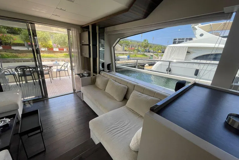  Yacht Photos Pics Luxurious interior of 2021 Ferretti Yachts 670 with modern furnishings and marina view.