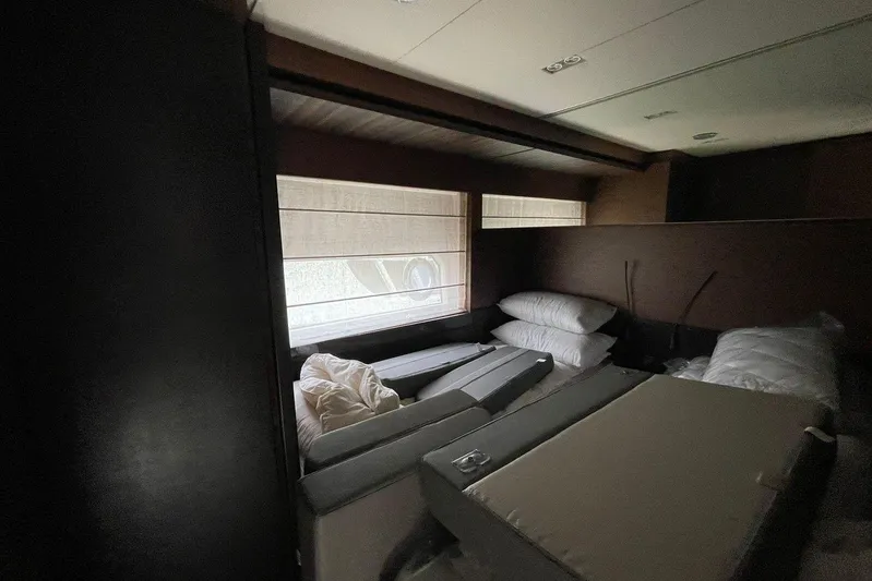  Yacht Photos Pics Interior cabin of 2021 Ferretti Yachts 670 with unmade bed and window view.