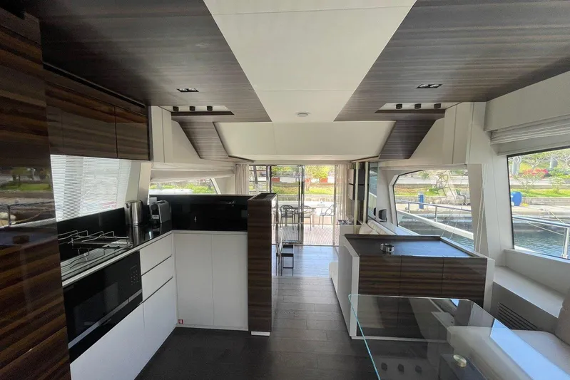  Yacht Photos Pics Luxurious interior of 2021 Ferretti Yachts 670 with modern kitchen and spacious seating area.