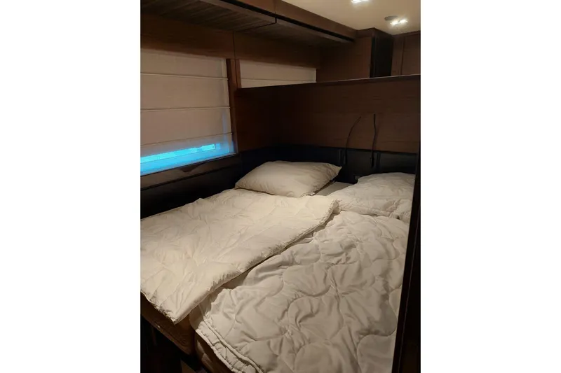  Yacht Photos Pics Luxurious bedroom interior of 2021 Ferretti Yachts 670 with cozy bedding.