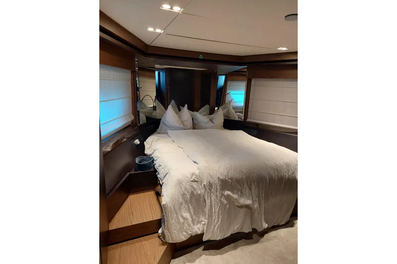  Yacht Photos Pics Luxurious bedroom interior of 2021 Ferretti Yachts 670 with elegant bedding and modern design.