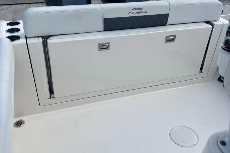  Yacht Photos Pics 2022 Cobia 280 Center Console boat seating and storage compartment.