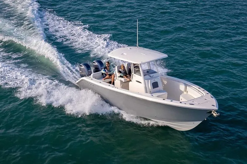  Yacht Photos Pics 2022 Cobia 280 Center Console boat cruising on open water.