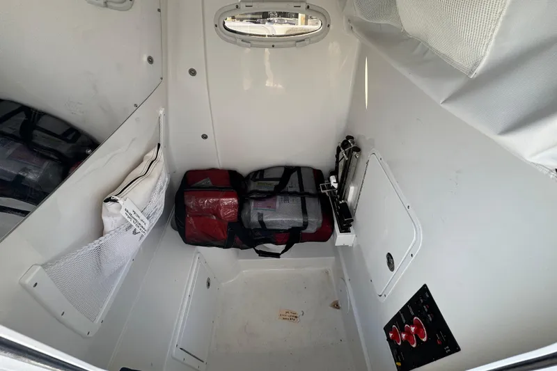  Yacht Photos Pics 2024 Sea Hunt Ultra 305 SE interior storage with bags and equipment.