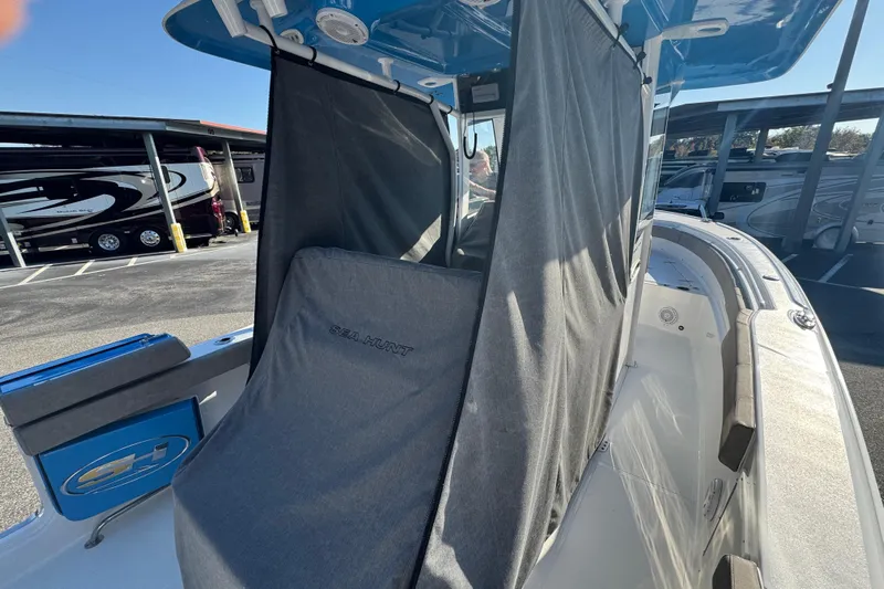  Yacht Photos Pics 2024 Sea Hunt Ultra 305 SE boat with covered seating area and modern design.