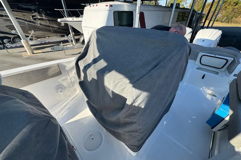  Yacht Photos Pics 2024 Sea Hunt Ultra 305 SE boat interior with covered seats in a storage area.