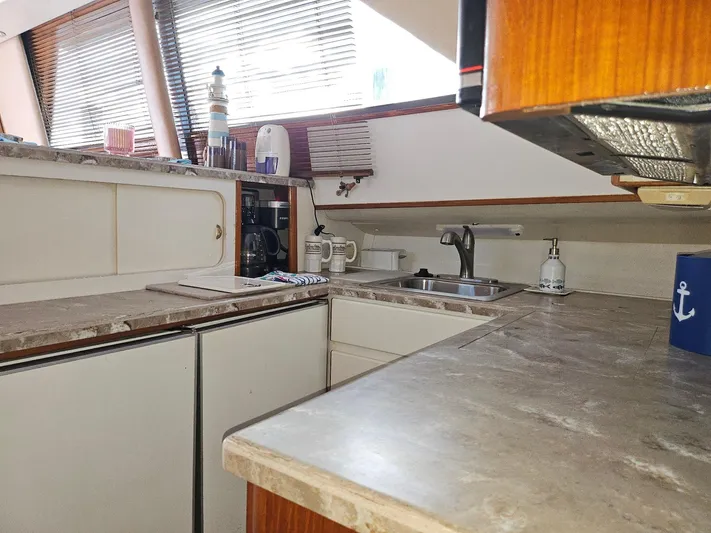 Relentless Yacht Photos Pics 1993 Tiara Yachts 4300 Convertible kitchen with marble countertops and modern appliances.