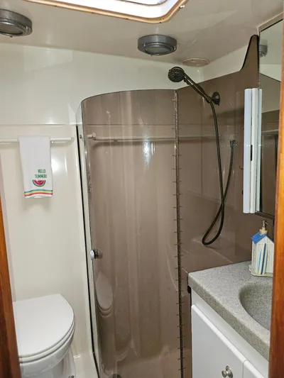 Relentless Yacht Photos Pics Bathroom interior of a 1993 Tiara Yachts 4300 Convertible, featuring a shower and sink.