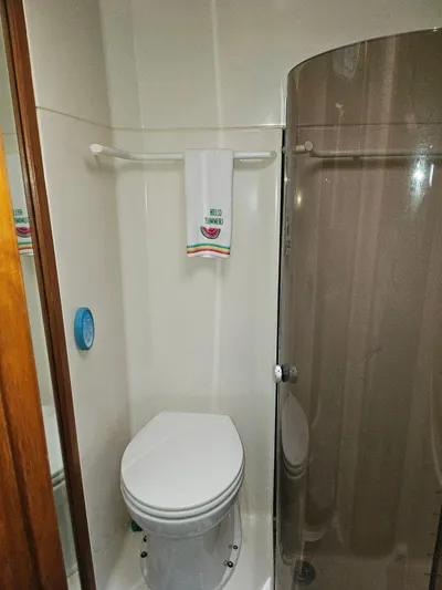 Relentless Yacht Photos Pics Bathroom in 1993 Tiara Yachts 4300 Convertible, featuring toilet and shower with "Hello Summer" towel.