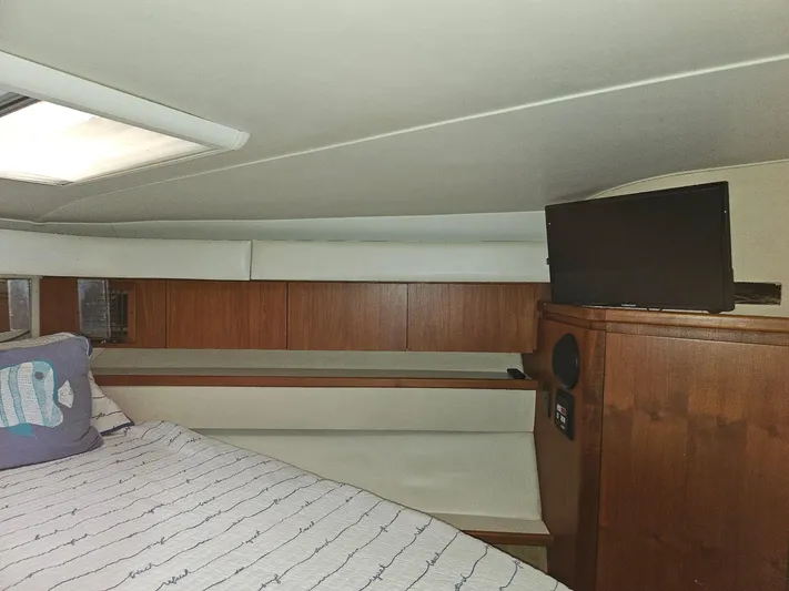 Relentless Yacht Photos Pics Interior of 1993 Tiara Yachts 4300 Convertible with bed, pillow, and TV.
