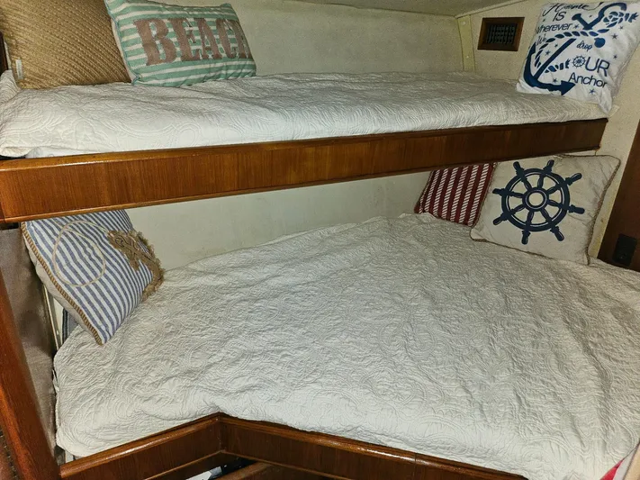 Relentless Yacht Photos Pics Bunk beds with nautical-themed pillows in a 1993 Tiara Yachts 4300 Convertible.