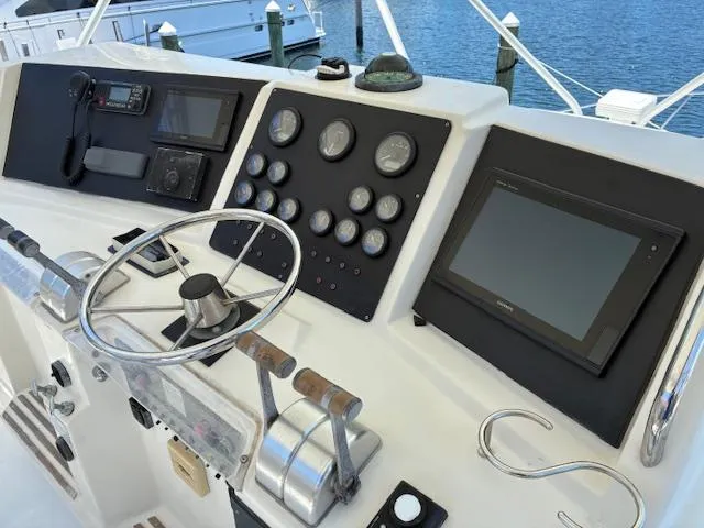 Relentless Yacht Photos Pics 1993 Tiara Yachts 4300 Convertible helm with steering wheel and navigation instruments.