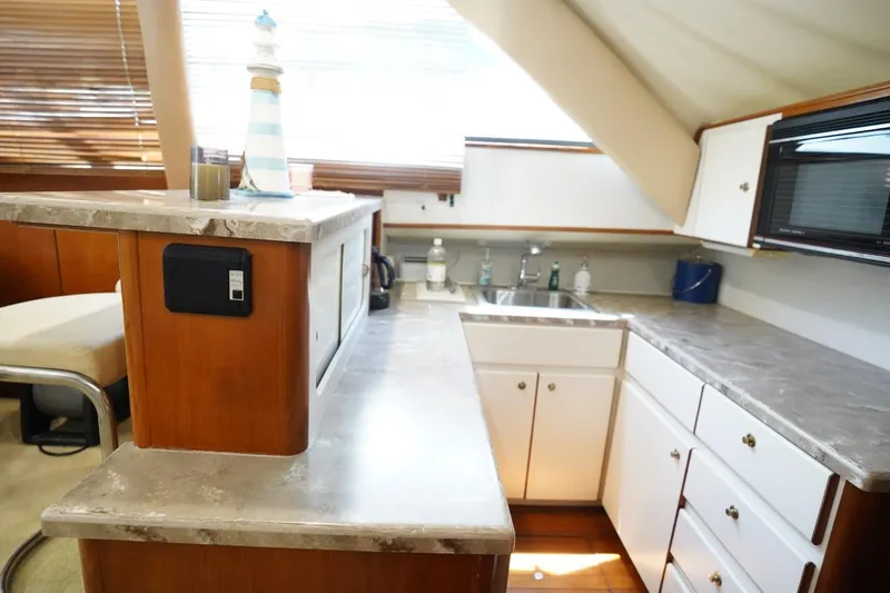 Relentless Yacht Photos Pics Interior of 1993 Tiara Yachts 4300 Convertible, featuring a modern kitchen with marble countertops.