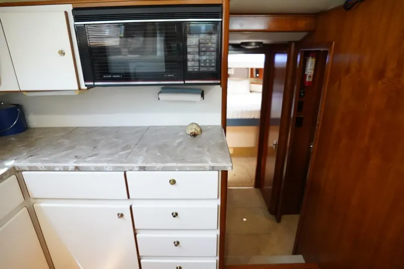 Relentless Yacht Photos Pics 1993 Tiara Yachts 4300 Convertible interior with kitchen and hallway view.
