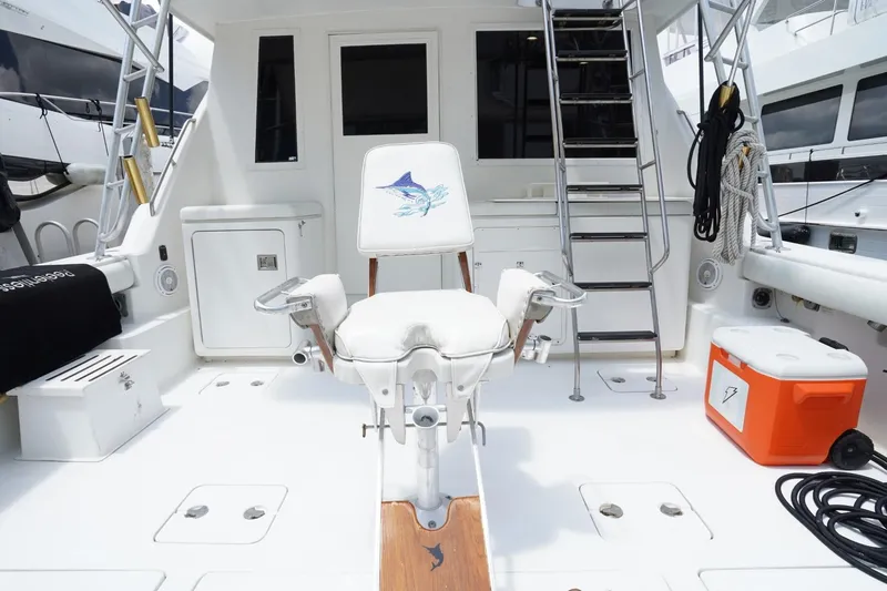 Relentless Yacht Photos Pics 1993 Tiara Yachts 4300 Convertible fishing deck with chair, ladder, and cooler.