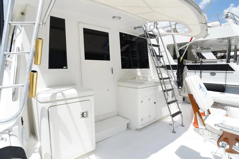 Relentless Yacht Photos Pics 1993 Tiara Yachts 4300 Convertible boat deck with ladder and seating area.